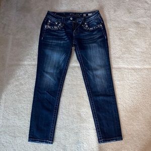 Miss Me signature crop skinny jeans. Blue and purple bedazzled front pockets.